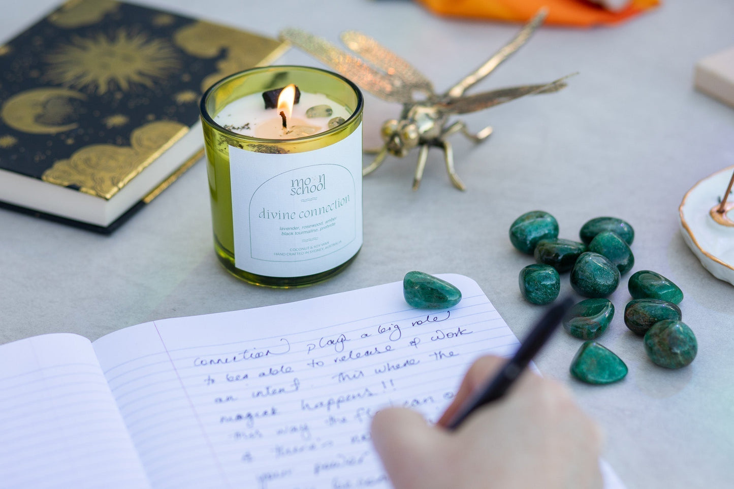 A lit ritual space with a candle and journal — for an essay on affirmations, intention, and what the nervous system can actually receive.