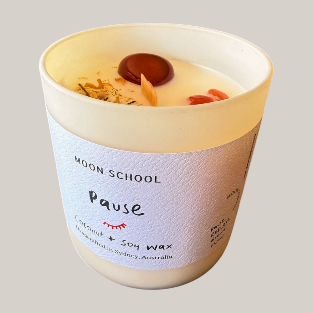 Pause Crystal Candle in a textured container with 'Moon School' label on a white background