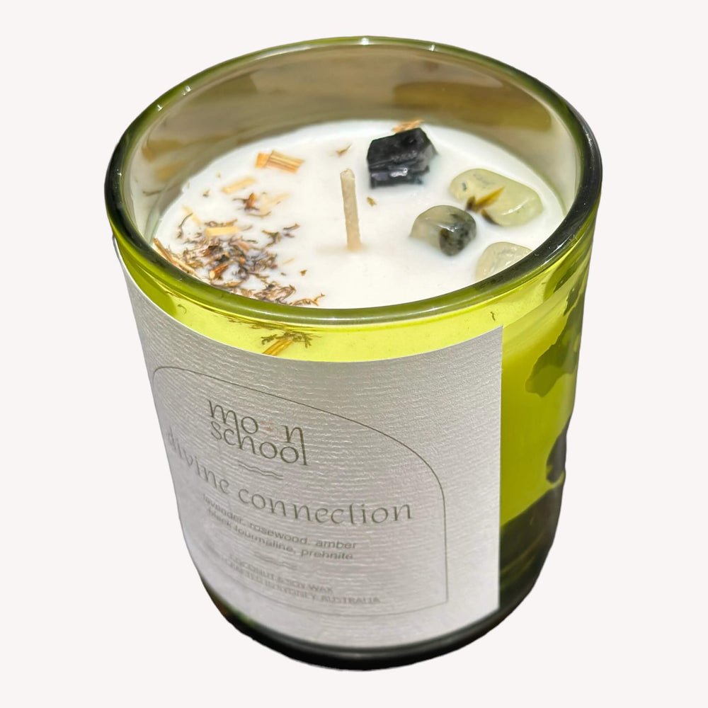 op view of Moon School's DIVINE CONNECTION Crystal Candle in the small size (200mls). Adorned with Black Tourmaline and Prehnite crystals, this candle enhances your connection to the divine with its grounding and harmonizing energies.