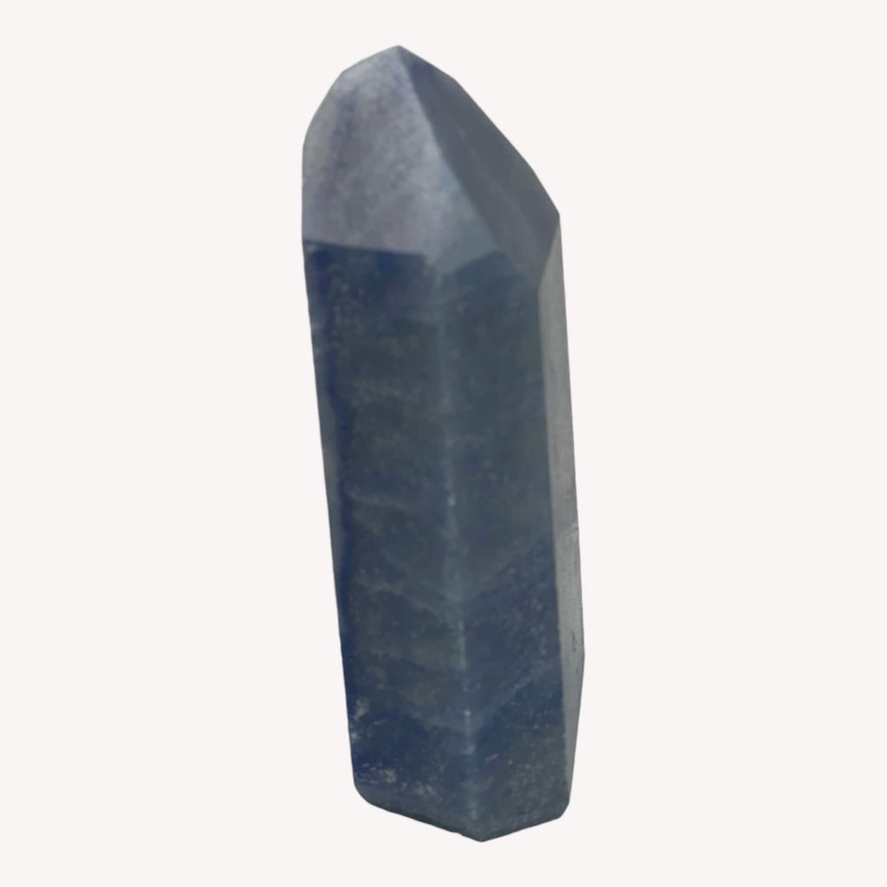 
                  
                    Side view of the small Blue Quartz Crystal Generator (Dumortierite), showcasing its intricate textures and natural formations. This petite crystal is a delightful addition for those seeking balance and serenity.
                  
                
