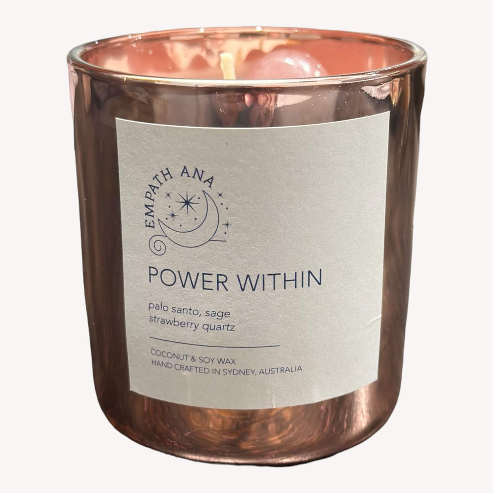 Front view of the Power Within Crystal Candle by Empath Ana, featuring a serene glow and Strawberry Quartz crystal.