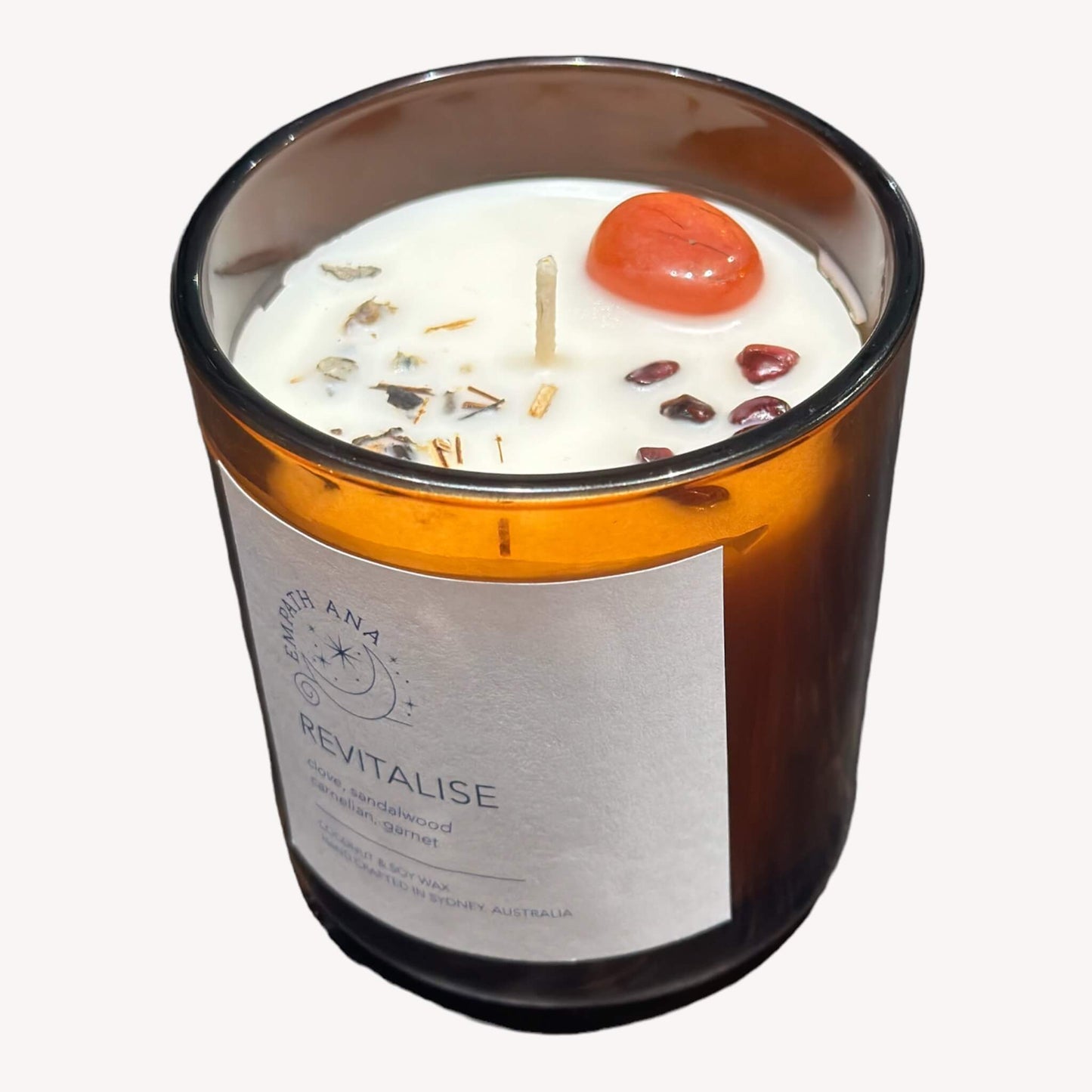 Top View of Medium Revitalise Crystal Candle - Vibrant Carnelian and Garnet Crystals.