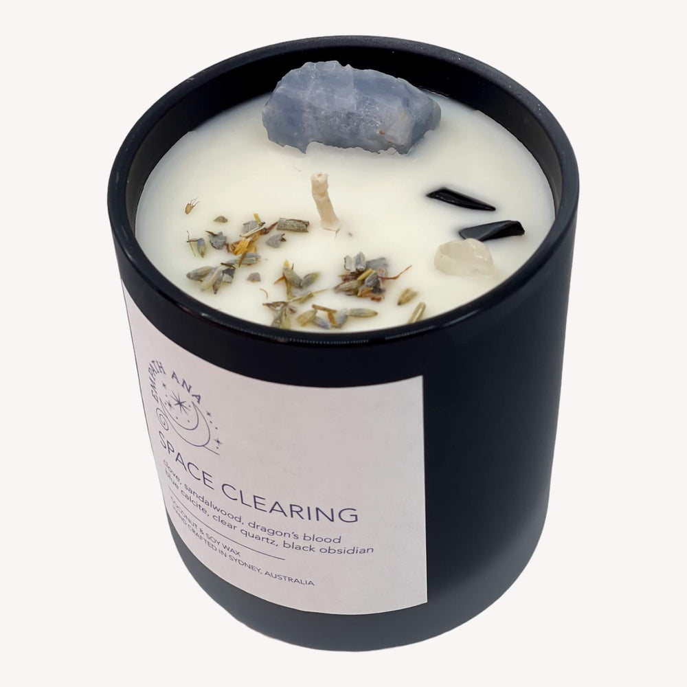 The top view of the Medium Space Clearing Crystal Candle, showcasing the beautiful arrangement of crystals and herbs.