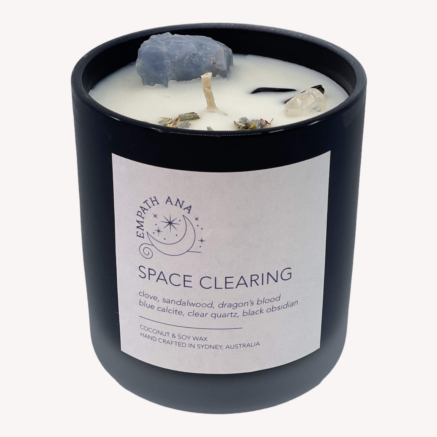 A captivating view of the Medium Space Clearing Crystal Candle, adorned with Blue Calcite, Clear Quartz, and Black Obsidian crystals.