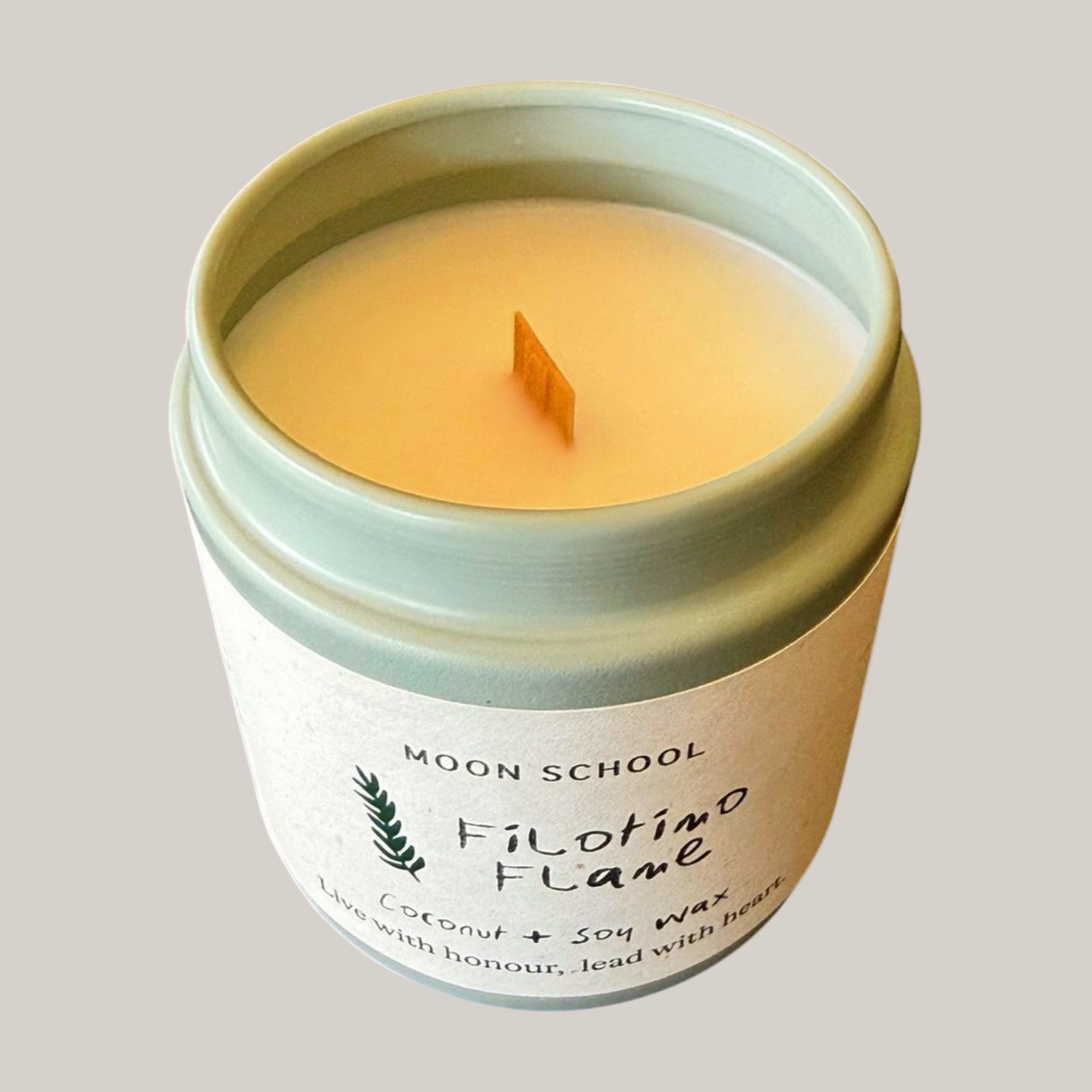 
                  
                    Top view of Candle in a sage metal tin for a Moon School candle called Filotmo Flame
                  
                