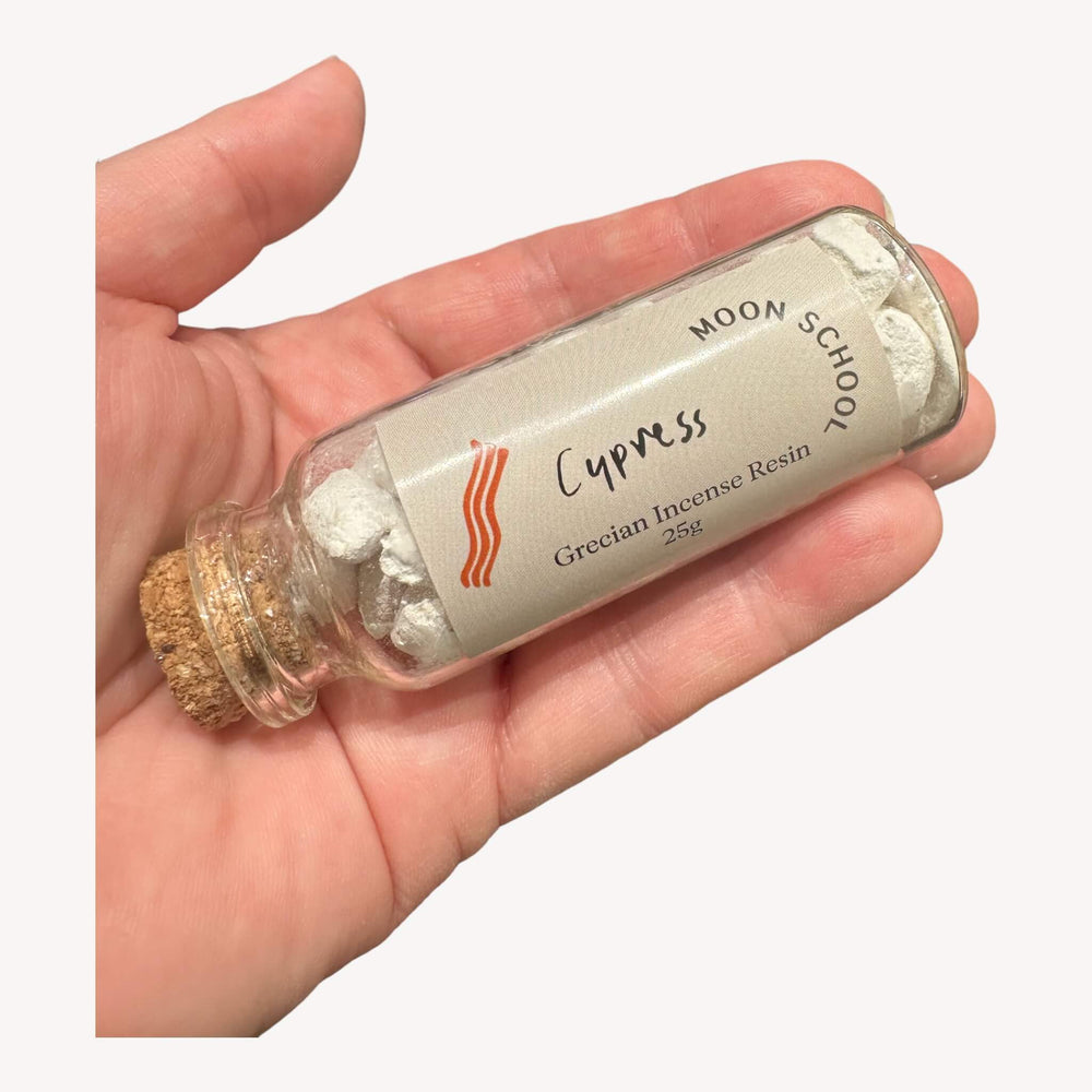Bottle of Grecian Cypress Incense Resin held in hand. Immerse in the serene embrace of this A Grade quality resin, meticulously curated amidst the verdant landscapes of Greece. Experience the calming and verdant aroma, creating an ambiance of tranquility and natural balance.