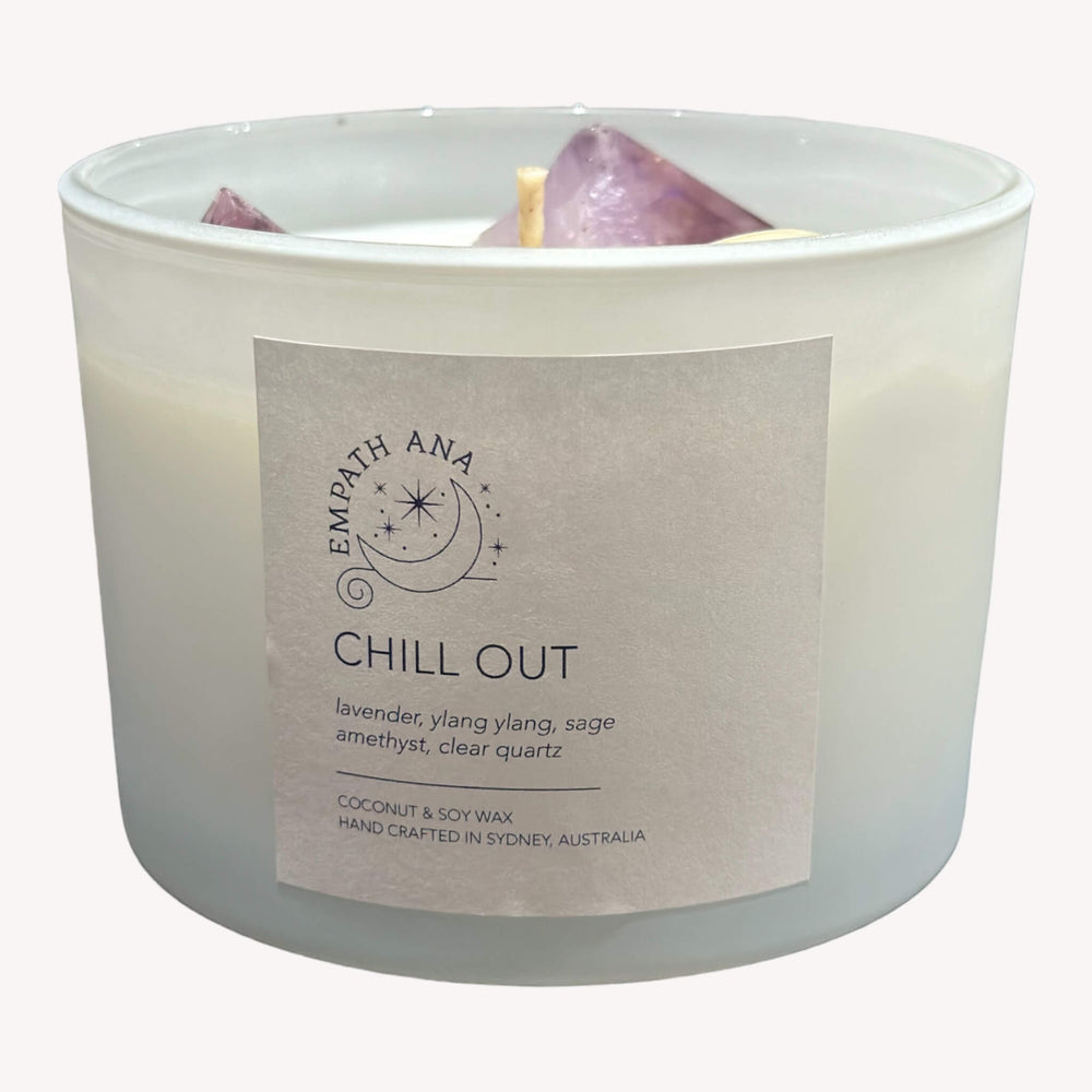 
                  
                    Front view of Empath Ana's Chill Out Crystal Candle in the X-Large size (500 mls). Clear Quartz crystals, Amethyst, and a blend of soothing herbs adorn the jar, promoting a tranquil atmosphere.
                  
                