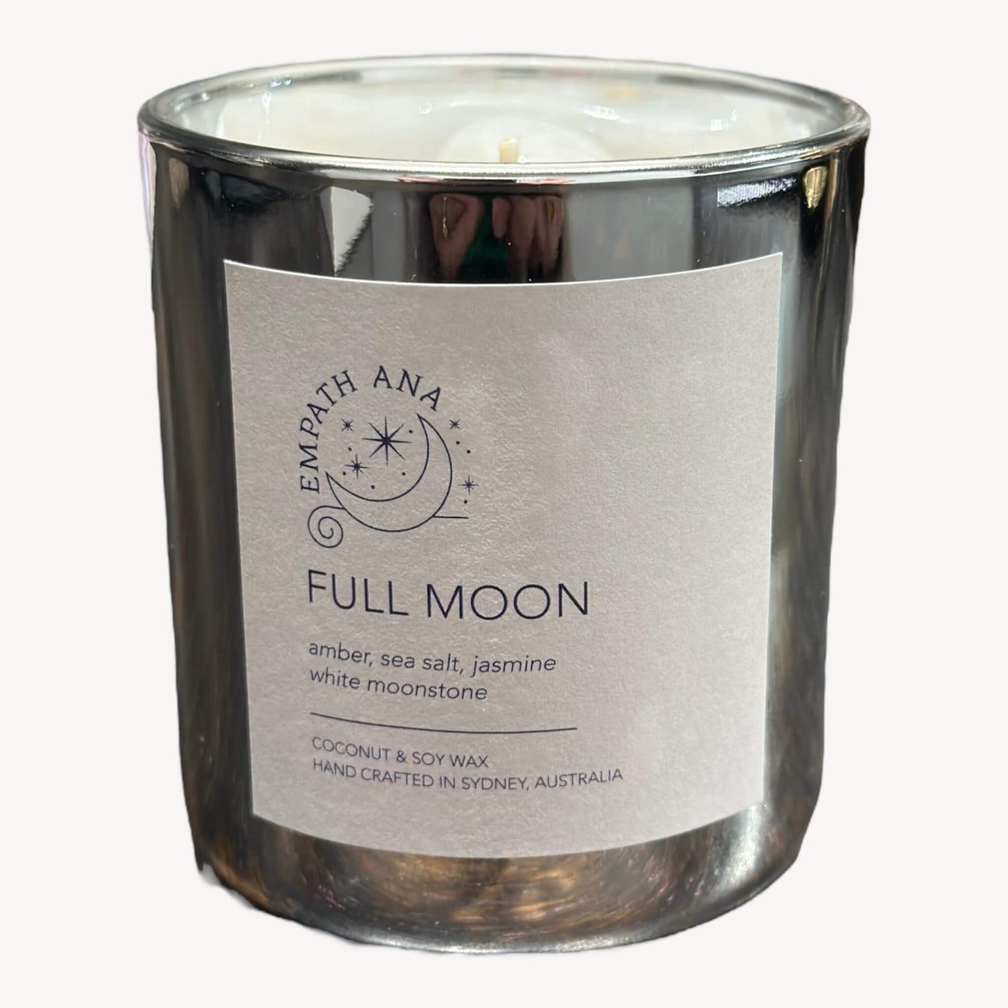 Front view of Empath Ana's Full Moon Crystal Candle in the Medium size (200mls). Hand-poured with care using Coconut/Soy Wax, this candle harnesses the potent energy of the Full Moon. Topped with White/Rainbow Moonstone, it's perfect for reflective moments and setting intentions.
