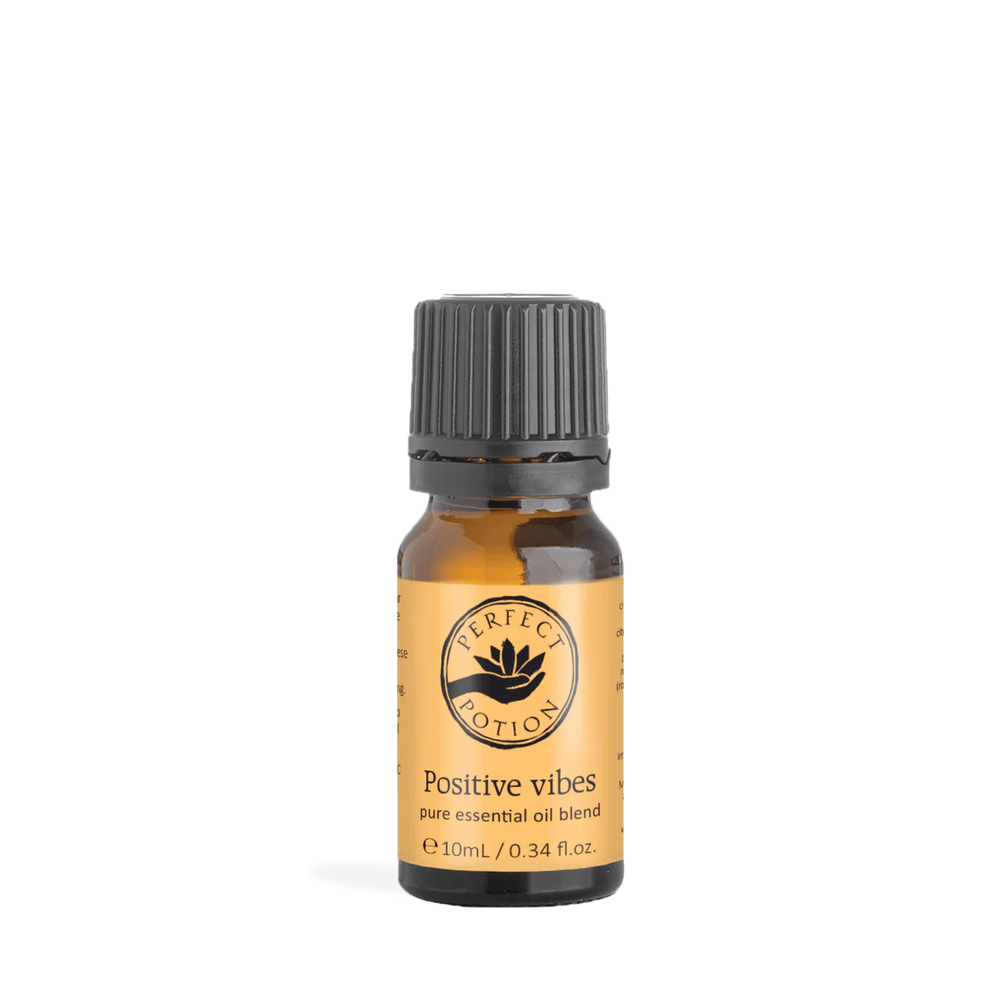 A bottle of Positive Vibes Blend essential oil, featuring a label with vibrant colors and the blend's uplifting ingredients.